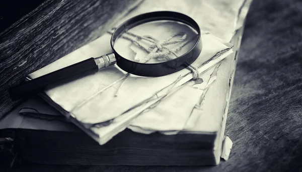 Magnifying glass analyzing paperwork